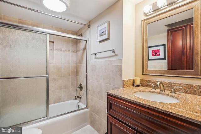 1239 Vermont Ave NW Unit 602, Washington, DC 20005 - bathroom featuring vanity, combined bath / shower with glass door, tile walls, and toilet