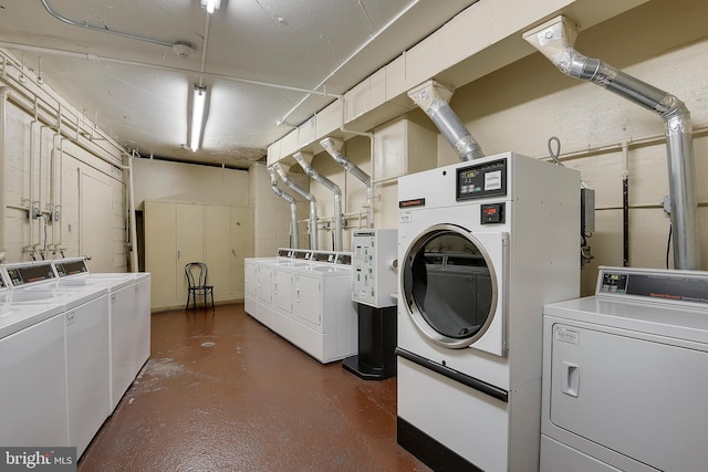 clothes washing area with separate washer and dryer