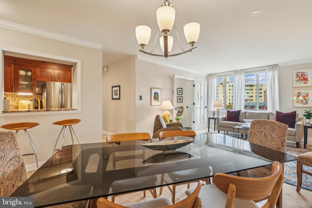 tiled dining space featuring ornamental molding and a chandelier