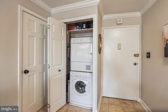 laundry room featuring stacked washer and clothes dryer and ornamental molding