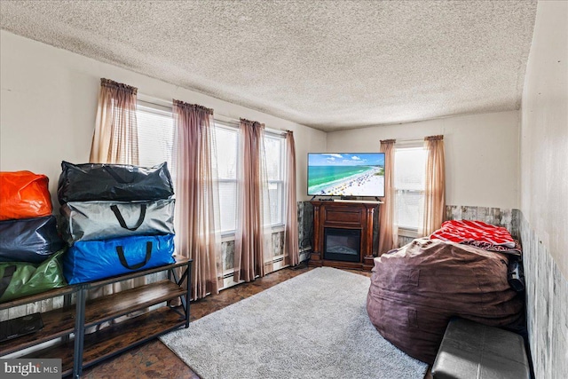 bedroom with multiple windows and a textured ceiling