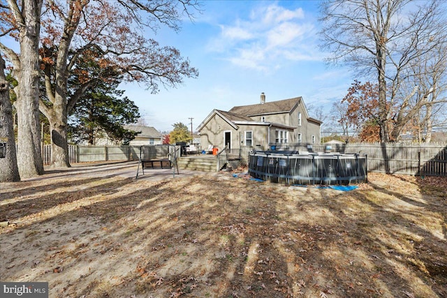 back of house with a swimming pool side deck