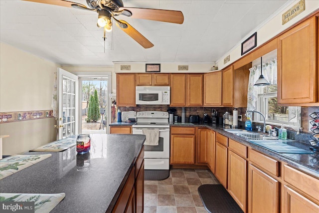 kitchen featuring tasteful backsplash, plenty of natural light, white appliances, and sink