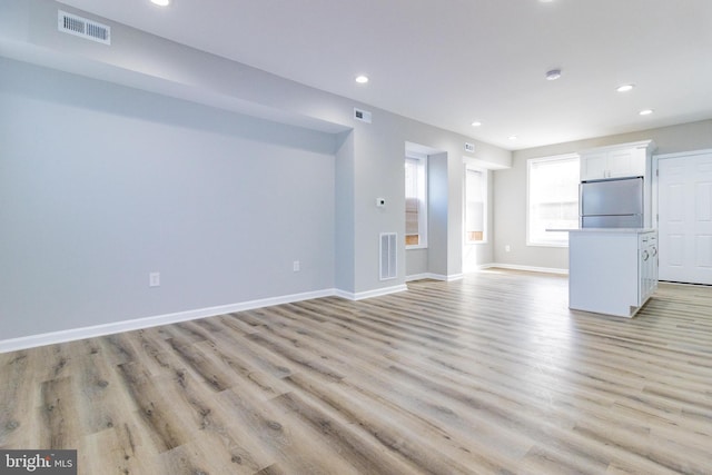 unfurnished living room with light wood-type flooring