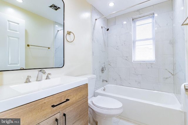 full bathroom featuring tiled shower / bath combo, toilet, and vanity