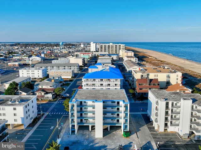 drone / aerial view with a beach view and a water view