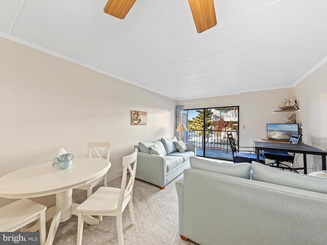 carpeted living room with ceiling fan and ornamental molding