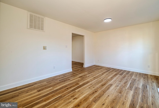 spare room featuring wood-type flooring