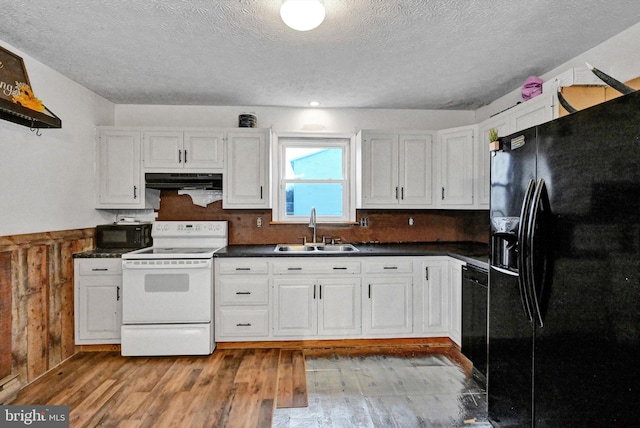 kitchen featuring light wood-type flooring, sink, white cabinets, and black appliances