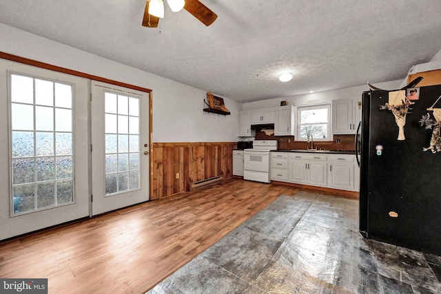 kitchen with baseboard heating, dark hardwood / wood-style flooring, white range with electric stovetop, a textured ceiling, and white cabinets