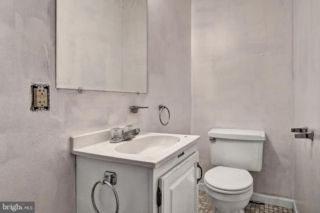 bathroom featuring tile patterned floors, vanity, and toilet