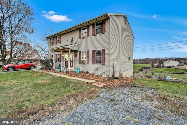 view of front of home featuring covered porch and a front lawn