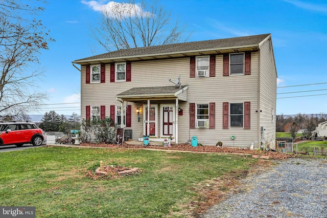 colonial house with a front lawn and cooling unit