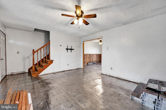 interior space with a textured ceiling and ceiling fan