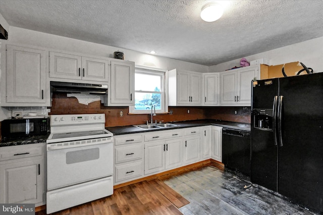 kitchen with black appliances, white cabinets, sink, and hardwood / wood-style flooring