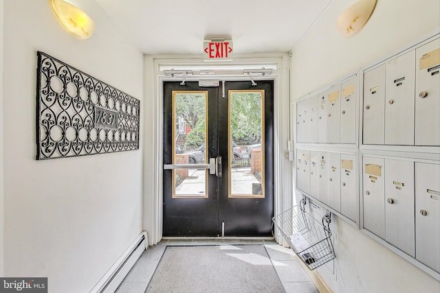 interior space with light tile patterned floors, baseboard heating, and a mail area