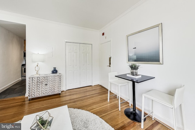 interior space featuring crown molding and hardwood / wood-style floors