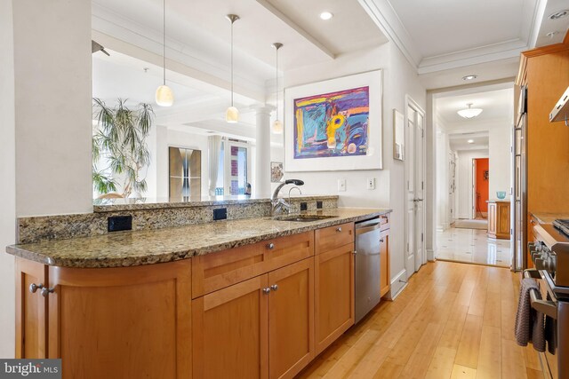 kitchen with light wood-type flooring, ornate columns, stainless steel appliances, decorative light fixtures, and stone countertops