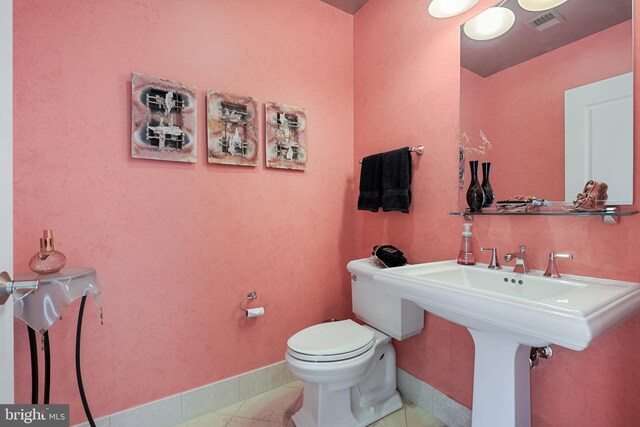 bathroom with tile patterned flooring and toilet