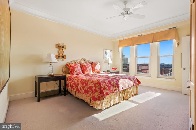 carpeted bedroom featuring ceiling fan and ornamental molding