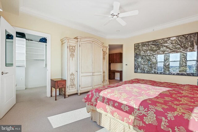 bedroom featuring a closet, light colored carpet, ceiling fan, and crown molding