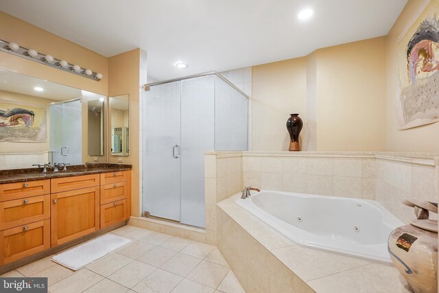 bathroom featuring plus walk in shower, vanity, and tile patterned floors