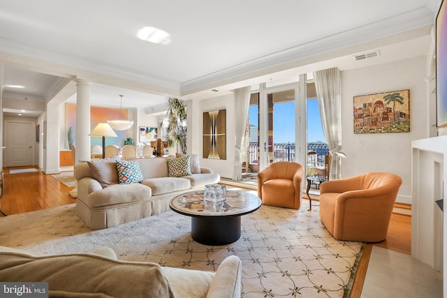 living room featuring light hardwood / wood-style floors and ornamental molding