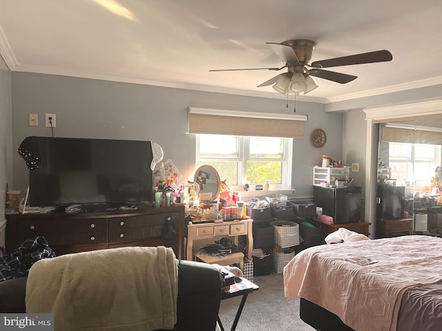 carpeted bedroom with ceiling fan and crown molding