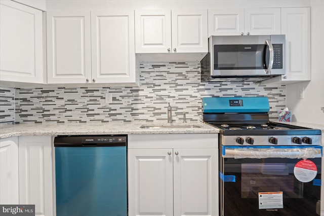 kitchen featuring sink, white cabinetry, and stainless steel appliances