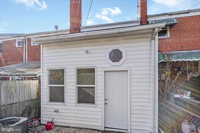 rear view of property featuring central air condition unit