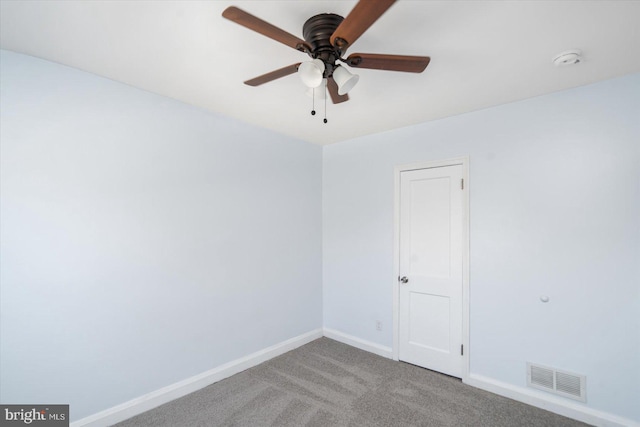 carpeted spare room featuring ceiling fan