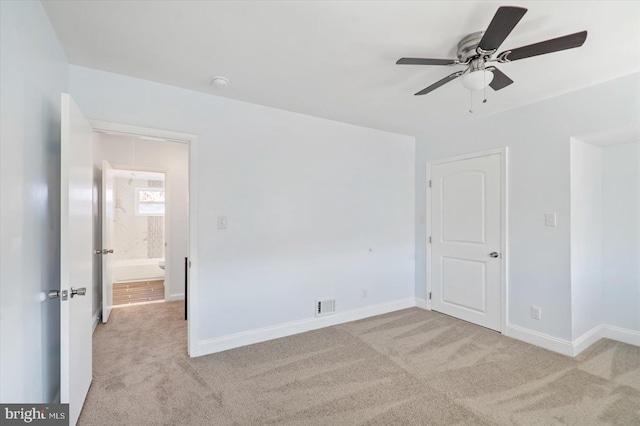 empty room featuring ceiling fan and light colored carpet