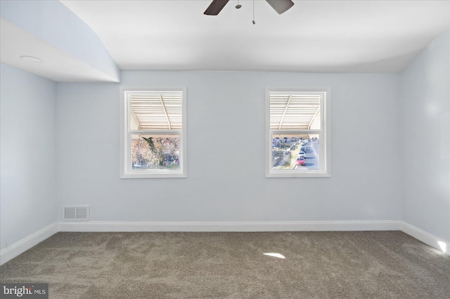 carpeted spare room with ceiling fan