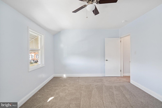 empty room featuring ceiling fan and carpet floors