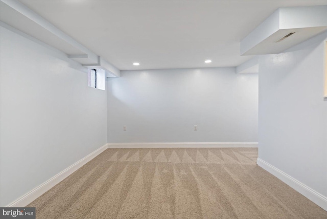 basement featuring light colored carpet