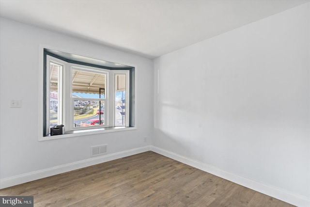 empty room with hardwood / wood-style flooring