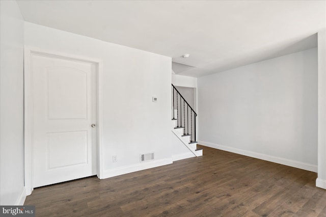 empty room featuring dark hardwood / wood-style flooring