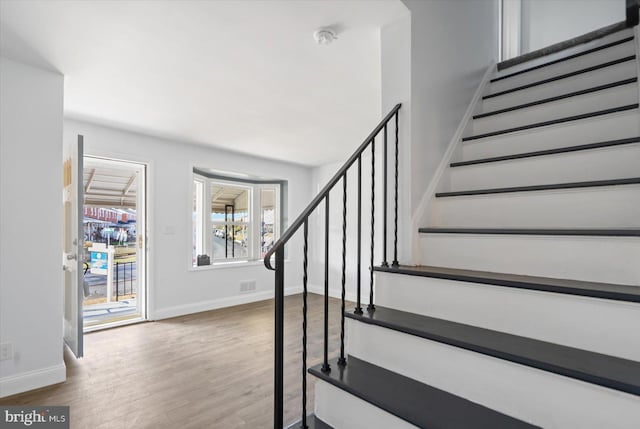 staircase with wood-type flooring