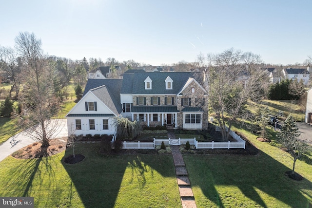 rear view of property featuring a yard and a balcony