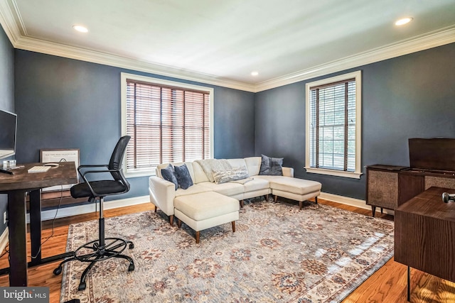 office featuring a healthy amount of sunlight, wood-type flooring, and ornamental molding