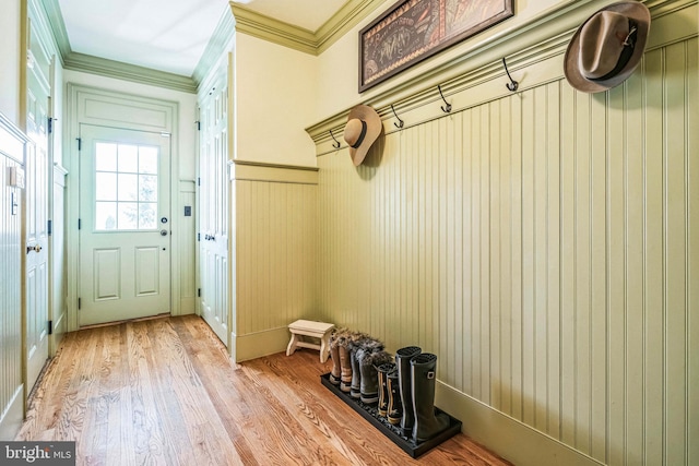 mudroom with ornamental molding and light hardwood / wood-style flooring