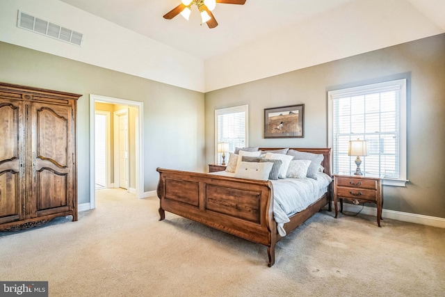 carpeted bedroom with multiple windows and ceiling fan