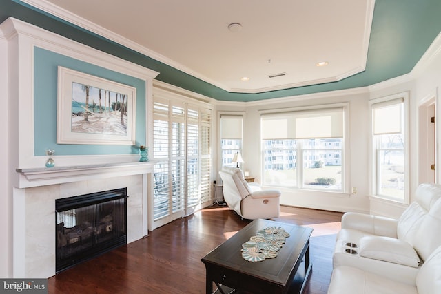 sitting room featuring a tile fireplace, dark hardwood / wood-style flooring, and ornamental molding