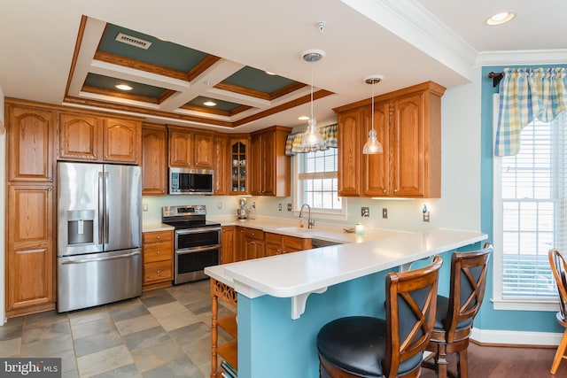 kitchen with a breakfast bar, a wealth of natural light, pendant lighting, and stainless steel appliances