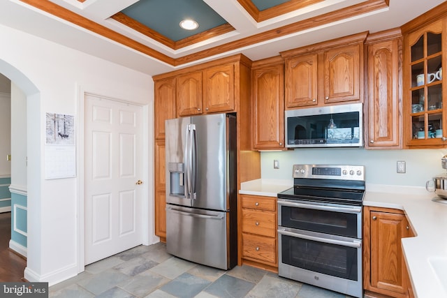 kitchen with beamed ceiling, ornamental molding, appliances with stainless steel finishes, and coffered ceiling