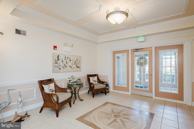 sitting room with crown molding, french doors, and light tile patterned floors