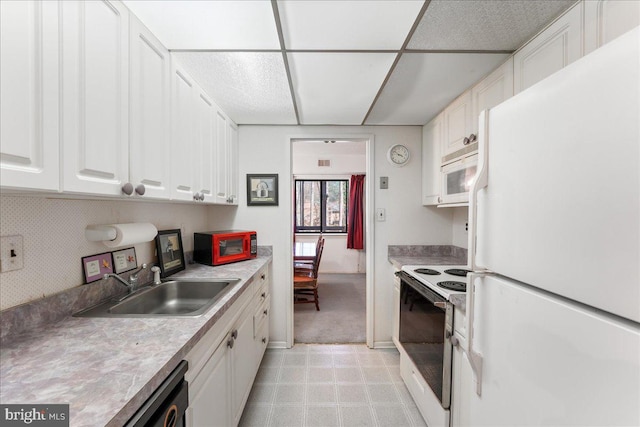 kitchen featuring sink, white cabinets, and white appliances