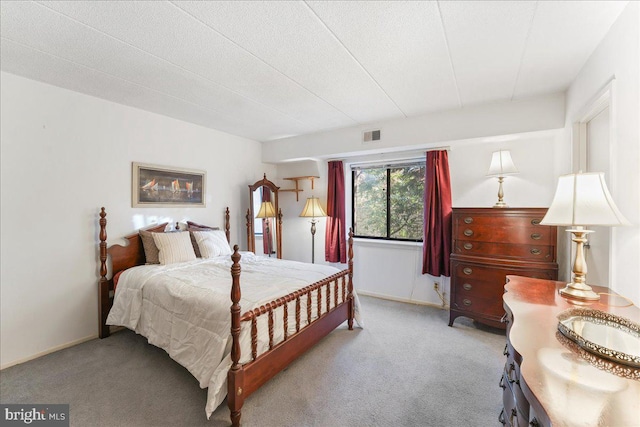 carpeted bedroom featuring a textured ceiling