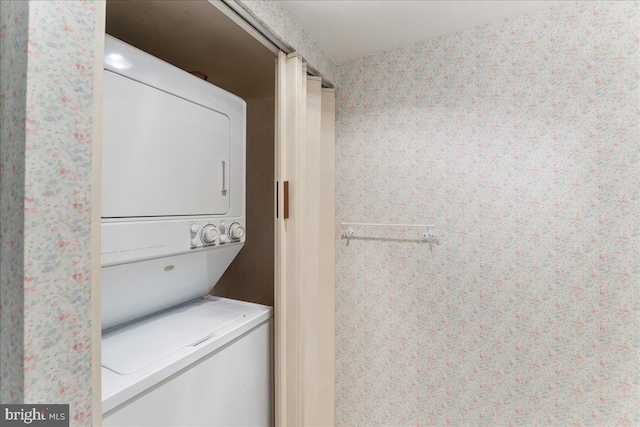 laundry area featuring stacked washer / drying machine