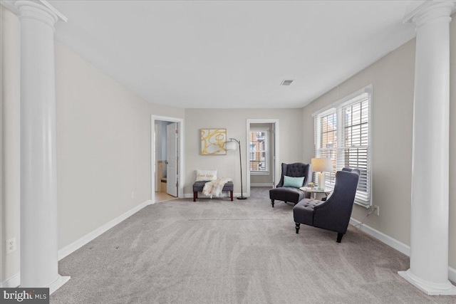 living area with baseboards, ornate columns, and carpet floors